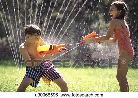 Stock Photograph -  family summer girl children kids playing squirt. Fotosearch