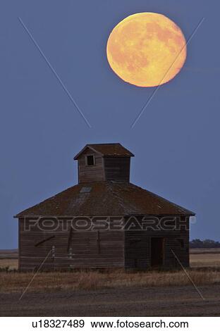 Stock Photo -  full moon over old barn weathered wood farm. Fotosearch