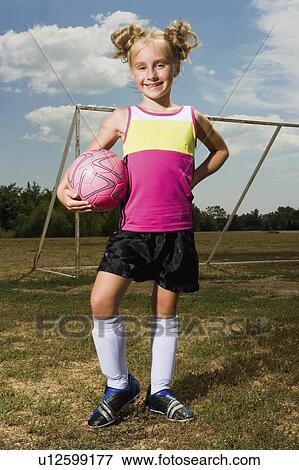 Stock Photo -  girl child soccer football kid field 5-6 years 7-9. Fotosearch