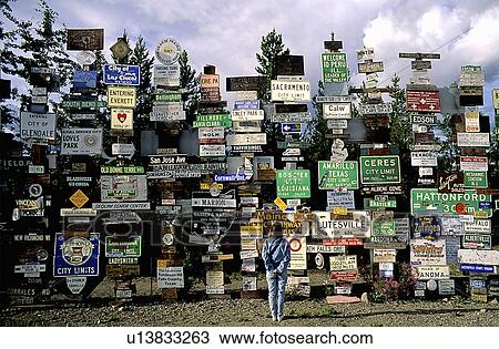 girl sign post forest watson lake yt canada View Large Photo Image Stock Image - girl sign post forest watson lake yt canada. Fotosearch