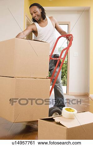 Stock Image -  house man person home moving day 20s 25-30 years. Fotosearch