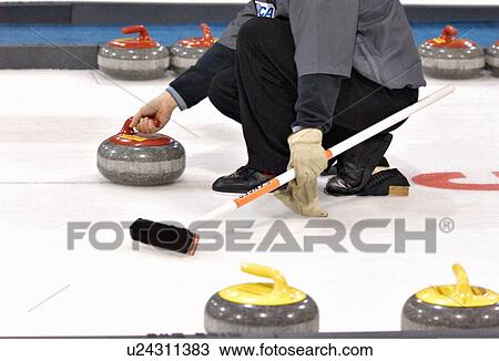 Stock Image -  house sport curler throwing curling rock sheet. Fotosearch