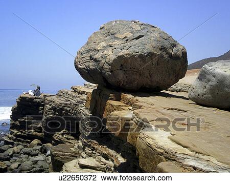 Stock Image -  large boulder in balance ocean scene san diego. Fotosearch