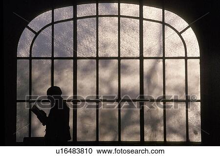 man sihouette of reading front glass window View Large Photo Image Stock Image - man sihouette of reading front glass window. Fotosearch