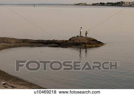 Stock Photo -  man sunset fort phoenix fishes nephew. Fotosearch