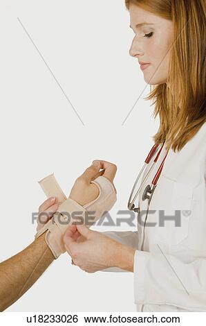 Stock Photograph -  medical people hand doctor treating carpal 25-30. Fotosearch
