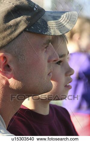 Stock Image -  mike stone tyler father son watching little game. Fotosearch
