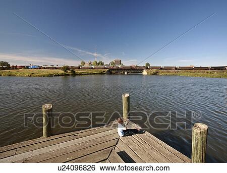 Stock Photograph -  people child kid young boy fishing wakamow park. Fotosearch