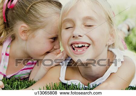 Stock Photo -  people children girls sharing secrets 34 years. Fotosearch