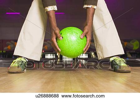 Stock Photo -  people sport person closeup holding bowling ball. Fotosearch