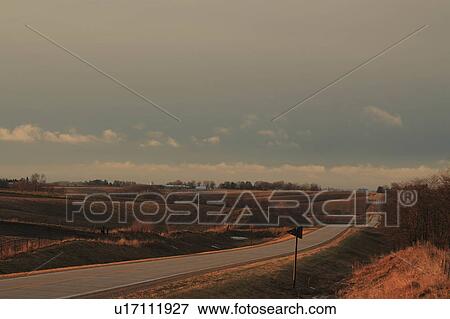 Stock Photo -  spring iowa cement country drive farm highway. Fotosearch