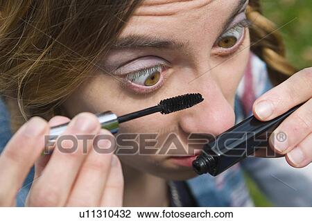 Stock Image -  woman beauty face young applying makeup model. Fotosearch