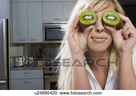 Stock Image -  woman girl fruit beauty face young acting goofy. Fotosearch