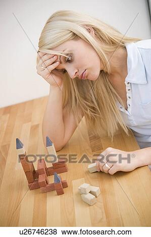 Stock Photo -  woman junge frau mit baukletzen young brick 25-30. Fotosearch
