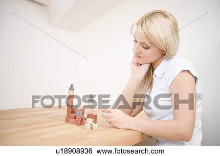 Stock Photograph -  woman junge frau mit baukletzen young brick 25-30. Fotosearch