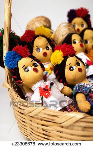 Stock Photo -  art closeup mexican dolls in wicker basket craft. Fotosearch