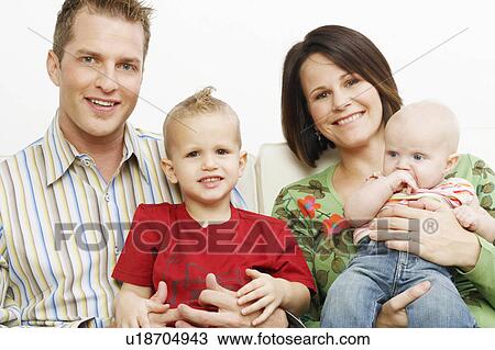 baby couple portrait mid adult sitting couch two sons View Large Photo Image Stock Image - baby couple portrait mid adult sitting couch two sons. Fotosearch