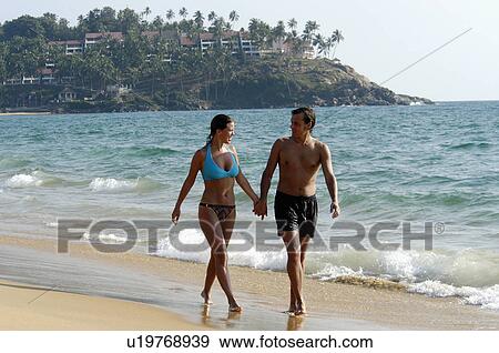 Stock Photo -  beach couple tourists in kovalam trivandrum pair. Fotosearch