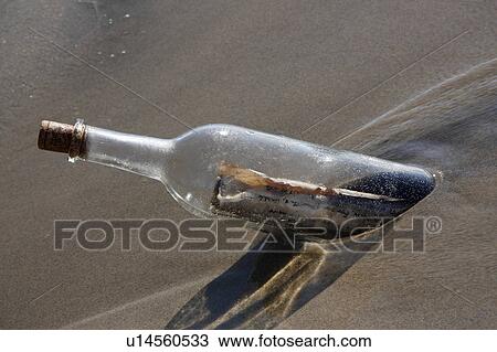 Stock Image -  beach water generic message in bottle theme sand. Fotosearch