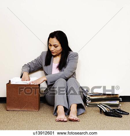 Stock Image -  business searching records in storage room 25-29 years. Fotosearch