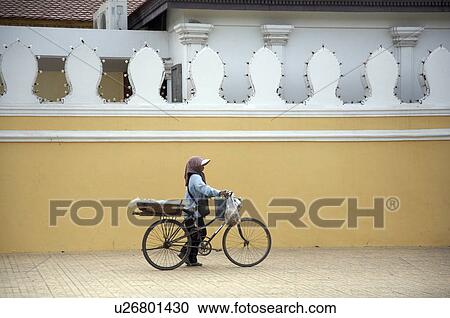 Stock Image -  business woman cambodia bicycle sells snacks se . Fotosearch