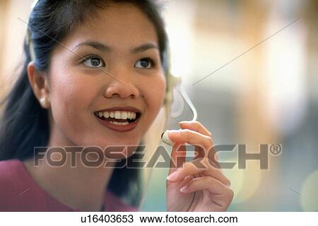 Stock Image -  business woman person face asian telephone 1 20s. Fotosearch