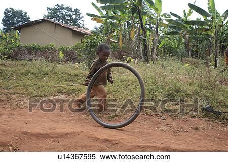 child children burundi boy playing bicycle tire View Large Photo Image Stock Photography - child children burundi boy playing bicycle tire . Fotosearch
