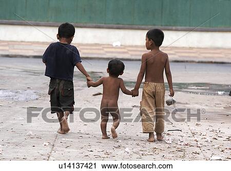 Stock Image -  child children cambodia three boys walking phnom . Fotosearch
