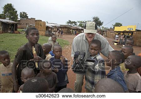 Stock Image -  child children uganda tony wilson filiming . Fotosearch