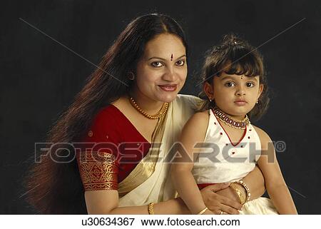 Stock Photo -  child mother kerala in attire onam daughter. Fotosearch