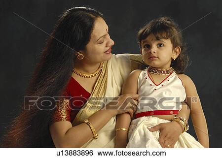 Stock Photograph -  child mother kerala in attire onam daughter. Fotosearch