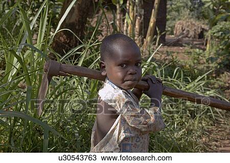 child uganda boy carrying hoe way work View Large Photo Image Stock Image - child uganda boy carrying hoe way work . Fotosearch
