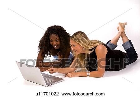 Stock Image -  computer internet laptop women two young aged. Fotosearch