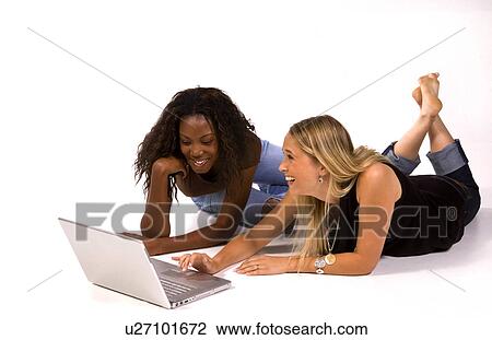 Stock Image -  computer internet laptop women two young aged. Fotosearch
