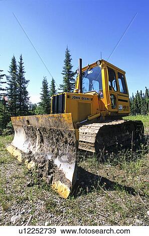 Stock Photo -  construction image bull dozer sitting level blue. Fotosearch