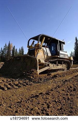 construction large bull dozer pushes mound earth View Large Photo Image Stock Image - construction large bull dozer pushes mound earth. Fotosearch