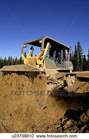 construction large bull dozer pushes mound earth View Large Photo Image Stock Image - construction large bull dozer pushes mound earth. Fotosearch