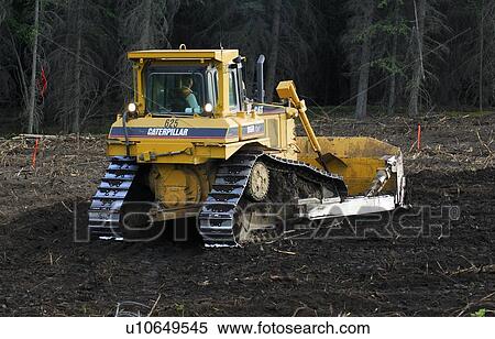 Stock Photography -  construction rear view large bull dozer pushing mound earth. Fotosearch