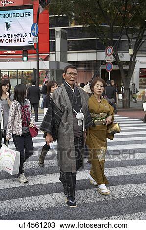Stock Image -  couple japan shibuya tokyo middle aged in dress . Fotosearch