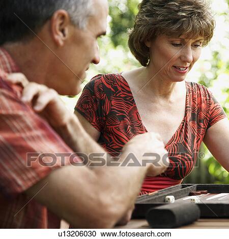 Stock Image -  couple mature playing board game 45-49 years. Fotosearch
