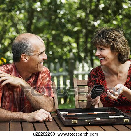 Stock Photo -  couple mature playing board game looking . Fotosearch
