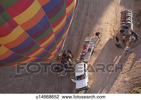 Stock Image -  crew preparing hot air ballon for flight over. Fotosearch