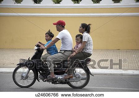Stock Photograph -  family child children cambodia motor cycle phnom . Fotosearch