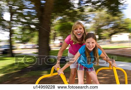 Stock Photo -  family child mother daughter having fun spinning. Fotosearch