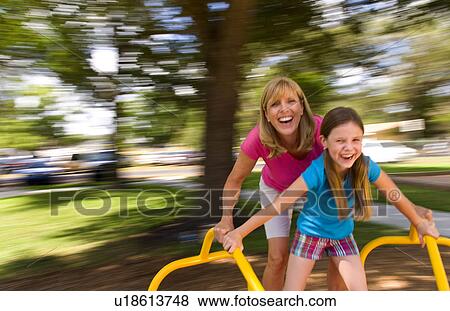 Stock Photo -  family child mother daughter having fun spinning. Fotosearch
