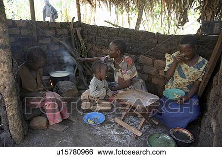 Stock Photograph -  family children fire home uganda in kasifa . Fotosearch
