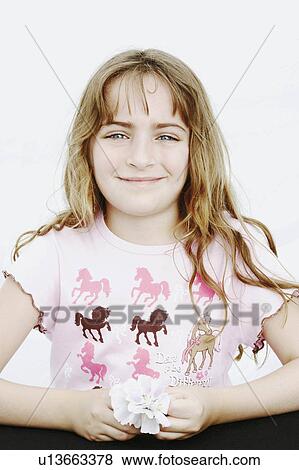 Stock Photo -  flower girl child portrait holding smiling 6-7 years. Fotosearch