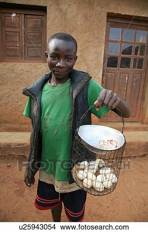 Picture -  food burundi boy selling eggs gitera africa sub . Fotosearch