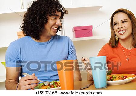 Stock Photo -  food couple young having breakfast smiling 20-24. Fotosearch
