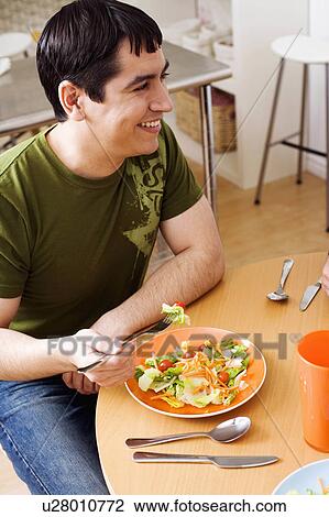 food man young sitting table eating salad 25-29 View Large Photo Image Stock Image - food man young sitting table eating salad 25-29. Fotosearch
